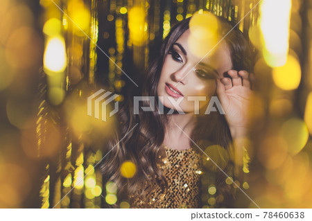 Beautiful young woman on golden party glitter bokeh background Beautiful young woman on golden party glitter bokeh background 78460638