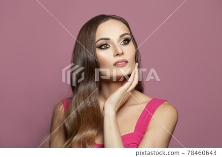 Glamorous brunette model woman with long shiny healthy hair and clear skin on pink background Glamorous brunette model woman with long shiny healthy hair and clear skin on pink background 78460643