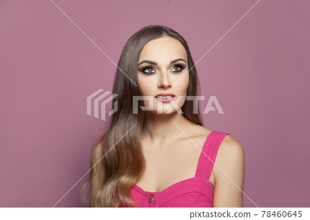 Fashion portrait of beautiful woman with makeup and long dark healthy hair looking up Fashion portrait of beautiful woman with makeup and long dark healthy hair looking up 78460645