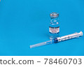 Vaccine for treatment of COVID-19 coronavirus with syringe on blue background with space for text. World vaccination against SARS-nCoV epidemic. Concept fighting and defeating coronavirus 2019-nCoV. 78460703