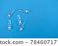 Glass ampoules for injection with coronavirus vaccine on blue background with space for text. Concept of fighting Sars-nCov, vaccinating people against Covid19 virus. Invention vaccine from 2019-nCoV 78460717
