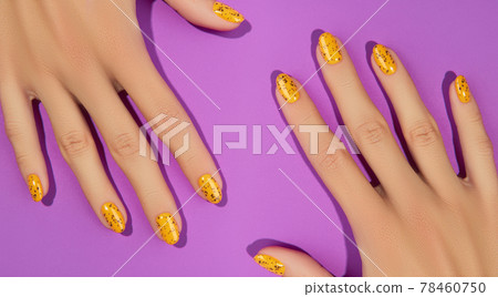 Manicured womans with trendy nail design on purple background Manicured womans with trendy nail design on purple background 78460750
