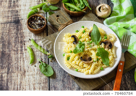 Healthy food. Homemade Pasta fusilli with green peas and grilled champignons on a wooden table.  Copy space. 78460784