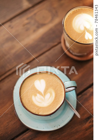 Mugs with latte on wooden table 78461343