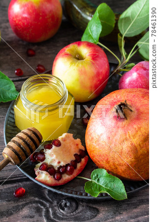 Rosh hashanah (hashana) - jewish new year holiday concept. Traditional symbols: honey, fresh apples, pomegranate and shofar on a wooden table. Rosh hashanah (hashana) - jewish new year holiday concept. Traditional symbols: honey, fresh apples, pomegranate and shofar on a wooden table. 78461390
