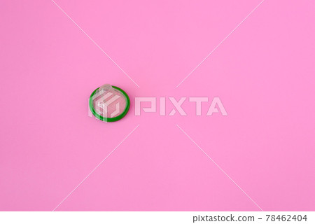 Green condom on pink paper background with copy space for text. Reproductive health and safe sex concept 78462404