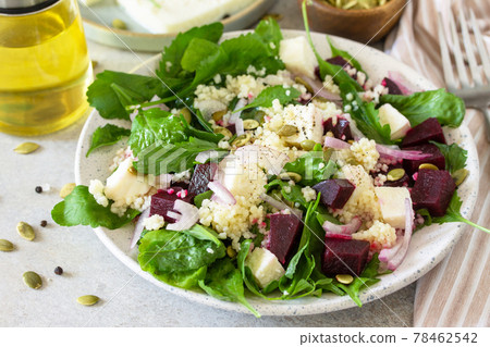 Healthy salad with couscous, soft cheese, beetroot and vinaigrette dressing. 78462542