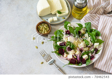 Healthy salad with couscous, soft cheese, beetroot and vinaigrette dressing. Copy space. Healthy salad with couscous, soft cheese, beetroot and vinaigrette dressing. Copy space. 78462543