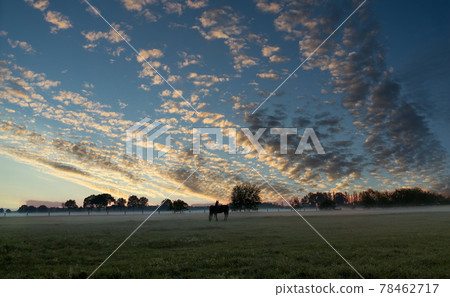 A group of clouds in the sky over a body of water A group of clouds in the sky over a body of water 78462717