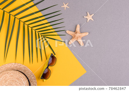 Beach accessories: glasses and hat with shells and sea stars on a colored background. Summer background Beach accessories: glasses and hat with shells and sea stars on a colored background. Summer background 78462847