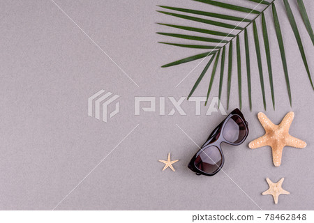 Beach accessories: glasses and hat with shells and sea stars on a colored background. Summer background Beach accessories: glasses and hat with shells and sea stars on a colored background. Summer background 78462848