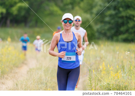 Young slim fitness girl running trail cross race Young slim fitness girl running trail cross race 78464101