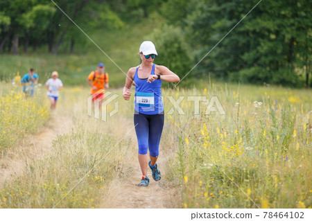 Young woman checking up her time on running cross 78464102