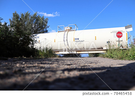 A train speeds past a stop sign at a crossing 78465458