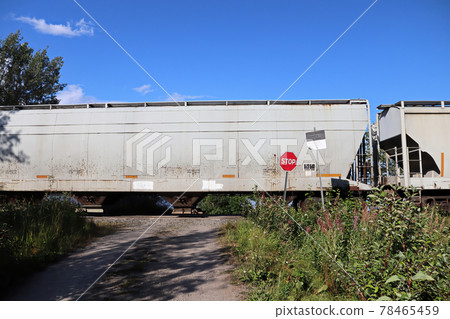 A train speeds past a stop sign at a crossing 78465459
