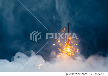 fire sparkler in dense smoke, abstract Christmas firework background fire sparkler in dense smoke, abstract Christmas firework background 78465795