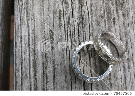 A pair of Hawaiian silver rings placed on the deck A pair of Hawaiian silver rings placed on the deck 78467566