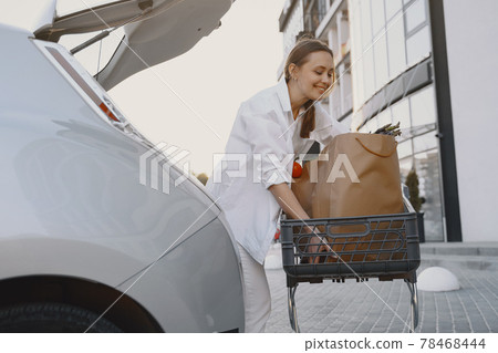 Woman charging electro car at the electric gas station Woman charging electro car at the electric gas station 78468444