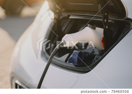 Woman charging electro car at the electric gas station Woman charging electro car at the electric gas station 78468508