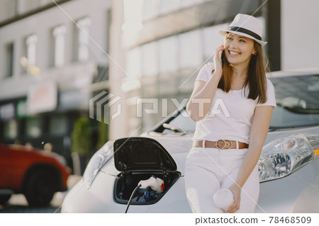 Woman charging electro car at the electric gas station Woman charging electro car at the electric gas station 78468509