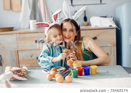 Mother with little daughter in a kitchen 78468574