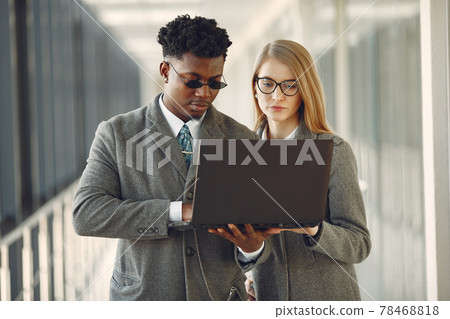 Businessman with his partner working in a office Businessman with his partner working in a office 78468818