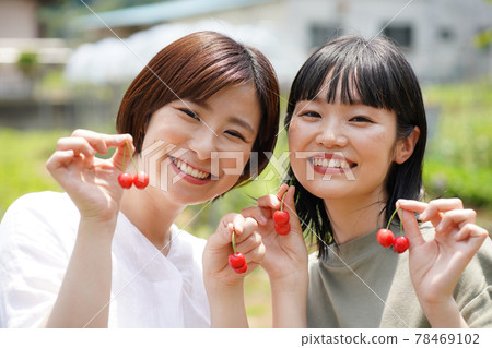 A woman with cherries 78469102