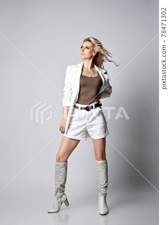 Gorgeous blonde woman in white shorts, jacket and 78471302