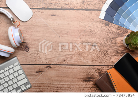 Graphic designer workspace with keyboard, headphone, color swatch and notebook on wooden background. 78473954
