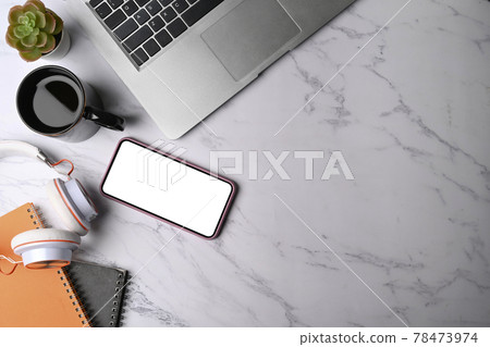 Top view smart phone, headphone, notebook and keyboard on marble background. Top view smart phone, headphone, notebook and keyboard on marble background. 78473974