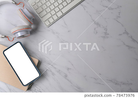 Mock up mobile phone, headphone, notebook and keyboard on marble background. Mock up mobile phone, headphone, notebook and keyboard on marble background. 78473976
