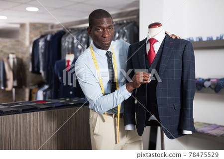 Person is creating business image with red tie in store Person is creating business image with red tie in store 78475529
