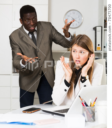 Upset woman with angry boss 78475700