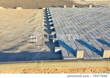 Process of installing paving bricks in the town pedestrian zone. Laying paving slabs  78477680