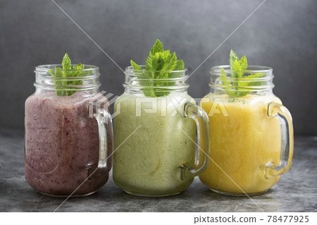 Assortment of fruit smothie in glass jars, summer refreshing drinks. 78477925