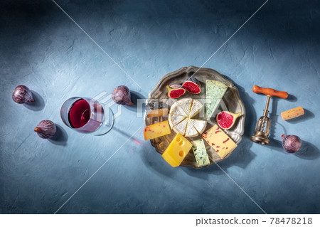 Cheese and wine tasting, overhead flat lay shot on a blue background Cheese and wine tasting, overhead flat lay shot on a blue background 78478218