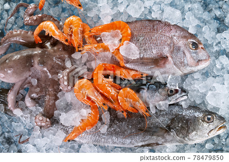 Close Up of Fresh Sea Fishes and Shrimps Lying on Crushed Ice. Close Up of Fresh Sea Fishes and Shrimps Lying on Crushed Ice. 78479850