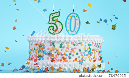 Colorful tasty birthday cake with candles shaped like the number 50. 78479915