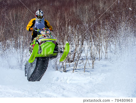Snowmobile in high jump above track. Selective focus Snowmobile in high jump above track. Selective focus 78480963