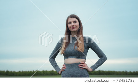 Portrait of beautiful woman smiling and living confidently, female healthy living and outdoors fitness concept. Portrait of attractive smiling happy brunette female. Nature background. Motivation 78481782