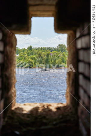 Observation window in the brick wall of the fortress for firing a gun with Observation window in the brick wall of the fortress for firing a gun with 78482412