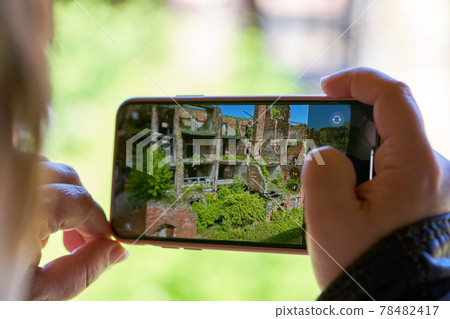 Taking a photo on a smartphone while traveling. Fortress Oreshek Taking a photo on a smartphone while traveling. Fortress Oreshek 78482417