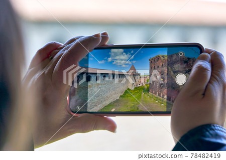 Taking a photo on a smartphone while traveling. Fortress Oreshek Taking a photo on a smartphone while traveling. Fortress Oreshek 78482419