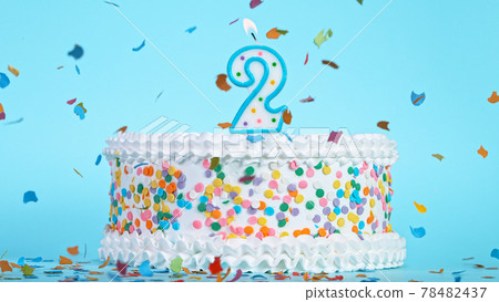 Colorful tasty birthday cake with candles shaped like the number 2. 78482437