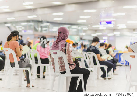 Muslim woman with hijab wait in a queue to receive covid-19 vaccine. Muslim woman with hijab wait in a queue to receive covid-19 vaccine. 78483004