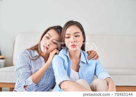 unhappy young woman share about her problem at home with her friend unhappy young woman share about her problem at home with her friend 78483144