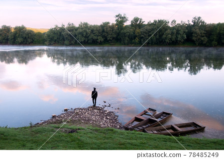Majestic foggy river and old wooden boats at sunrise Majestic foggy river and old wooden boats at sunrise 78485249