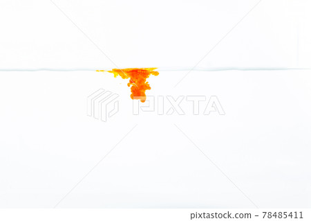 Yellow ink splashes into the water. 78485411