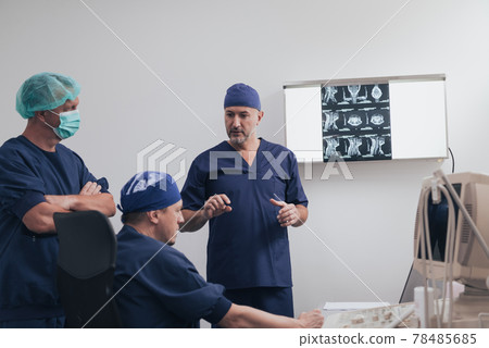 Orthopedist doctor team examining digital X-ray picture in clinic or hospital Orthopedist doctor team examining digital X-ray picture in clinic or hospital 78485685