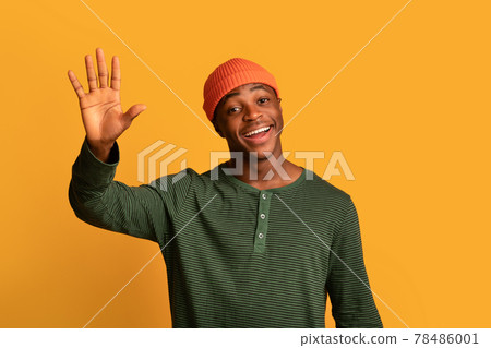 Hello. Portrait Of Friendly Young African American Guy Waving Hand At Camera Hello. Portrait Of Friendly Young African American Guy Waving Hand At Camera 78486001